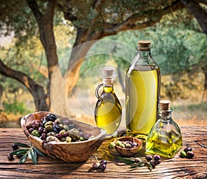 Olives and olive oil in a bottle.