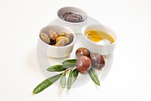 Olives and olive oil on white background