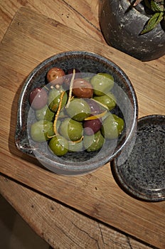 Olives with orange zest and spices as appetizer