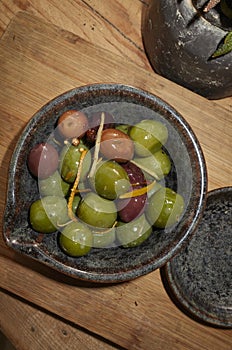 Olives with orange zest and spices as appetizer