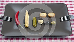 Olives, pickled cucumber, pepper, mushrooms and corn in a salad on a plate. food and vegetables. diet and weight loss
