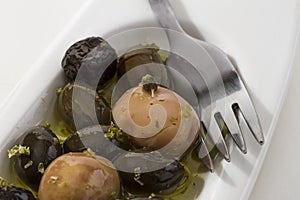 Olives, spice, oil and fork