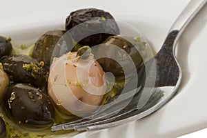 Olives, spice, oil and fork