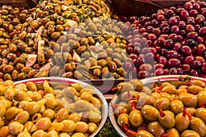 Olives under various marinades on the counter