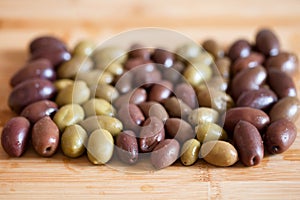 Olives on wooden background, kalamata, kalamon, green olives