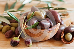 Olives on wooden background, kalamata, kalamon, green olives