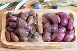 Olives on wooden background, kalamata, kalamon, green olives