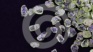 Olivine jewel heap up texture on black background. Moving right seamless loop backdrop