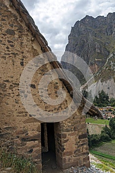 Ollantaytambo ruins, a massive Inca fortress with large stone terraces on a hillside, tourist destination in Peru