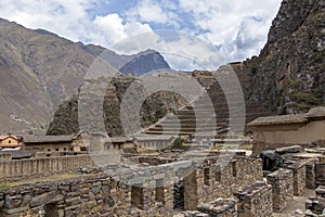 Ollantaytambo ruins, a massive Inca fortress with large stone terraces on a hillside, tourist destination in Peru