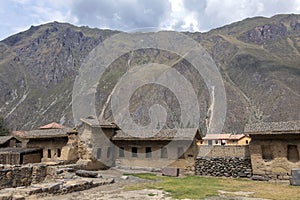Ollantaytambo ruins, a massive Inca fortress with large stone terraces on a hillside, tourist destination in Peru