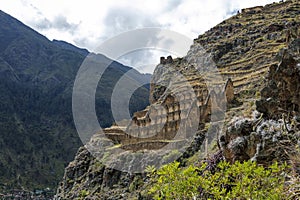 Ollantaytambo ruins, a massive Inca fortress with large stone terraces on a hillside, tourist destination in Peru