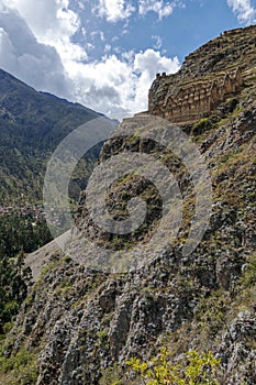 Ollantaytambo ruins, a massive Inca fortress with large stone terraces on a hillside, tourist destination in Peru