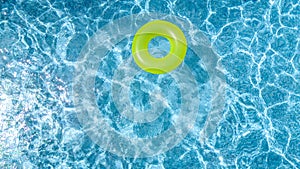 Ð¡olorful inflatable ring donut toy in swimming pool water aerial view from above, family vacation holiday resort