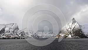 Olstinden mountain and Reinefjorden from Toppoy island on the Lofoten in Norway in winter