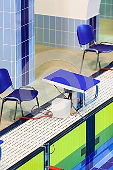 Olympic-sized swimming pool with starting blocks with yellow touch panels for a competition