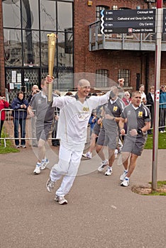 Olympic Torchbearer Paul Giblin with the torch