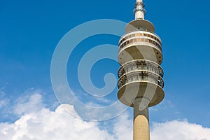Olympic Tower or Olympiaturm in Munich, Germany. Detail of top on blue sky background. This tower is a famous landmark of Munich