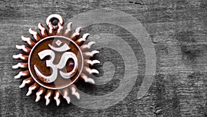 Om pendent on wood background and greeting