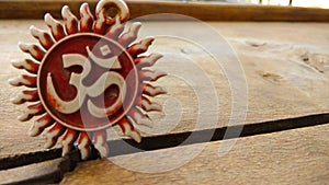 Om pendent on wood background and greeting