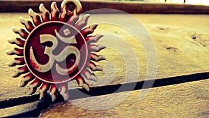 Om pendent on wood background and greeting