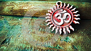 Om pendent on wood background and greeting