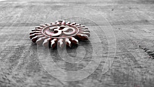 Om pendent on wood background and greeting