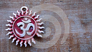 Om pendent on wood background and greeting