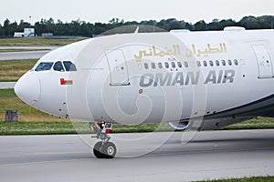 Oman Air taxiing on runway, close-up view