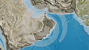 Oman border shape overlay. Glowed. Satellite.