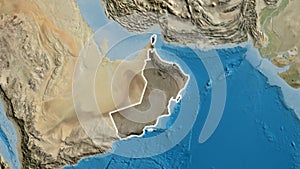 Oman border shape overlay. Glowed. Satellite.