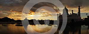 Omar Ali Saifuddien Mosque during sunset with reflection in the calm pond water in Bandar Seri Begawan, Brunei.