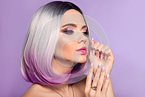 Ombre bob short hairstyle. Woman portrait with blond purple hair and manicured nails. Beauty makeup. Beautiful girl model isolated