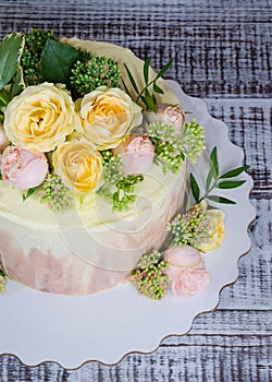 Ombre wedding cake decorated with roses and some greenery