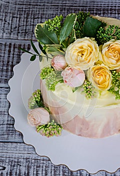 Ombre wedding cake decorated with roses and some greenery