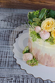 Ombre wedding cake decorated with roses and some greenery