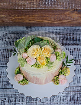 Ombre wedding cake decorated with roses and some greenery