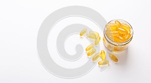 Omega 3 capsules in glass jar on white background Fish oil Yellow softgels Vitamin D, E, A supplement