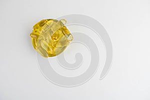 Omega 3 capsules lying in the lid on a white background. Copy space for text