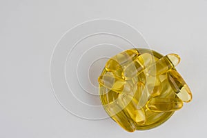 Omega 3 capsules lying in the lid on a white background. Copy space for text