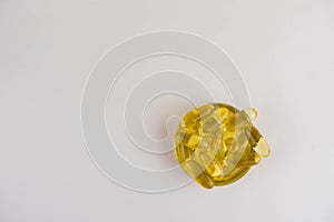 Omega 3 capsules lying in the lid on a white background. Copy space for text