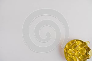 Omega 3 capsules lying in the lid on a white background. Copy space for text