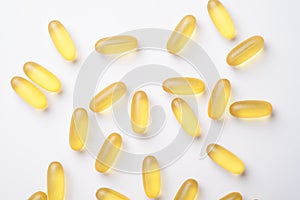 Omega 3 capsules on white background. Fish oil softgels. Supplement food vitamin D capsules. Top view