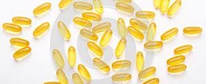 Omega 3 capsules on white background Fish oil Yellow softgels Vitamin D, E, A supplement Concept of healthcare Banner