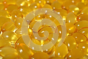 Omega-3 fish fat oil capsules as background texture.