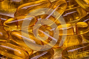 Omega-3 fish fat oil capsules as background texture