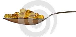 Omega-3 fish fat oil capsules in spoon on a white