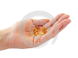 Omega 3 fish oil capsules on the palm  on white background