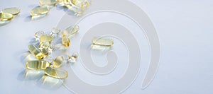 Omega 3 fish oil gel capsules, vitamin E. Close-up medicine yellow transparent pills, omega 3 fish oil capsules, vitamin