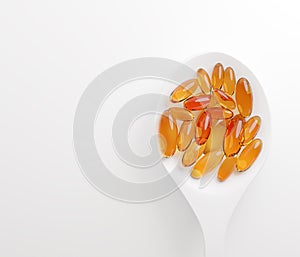 Omega 3 gel capsules or Cod liver oil top view on white background health care supplement concept